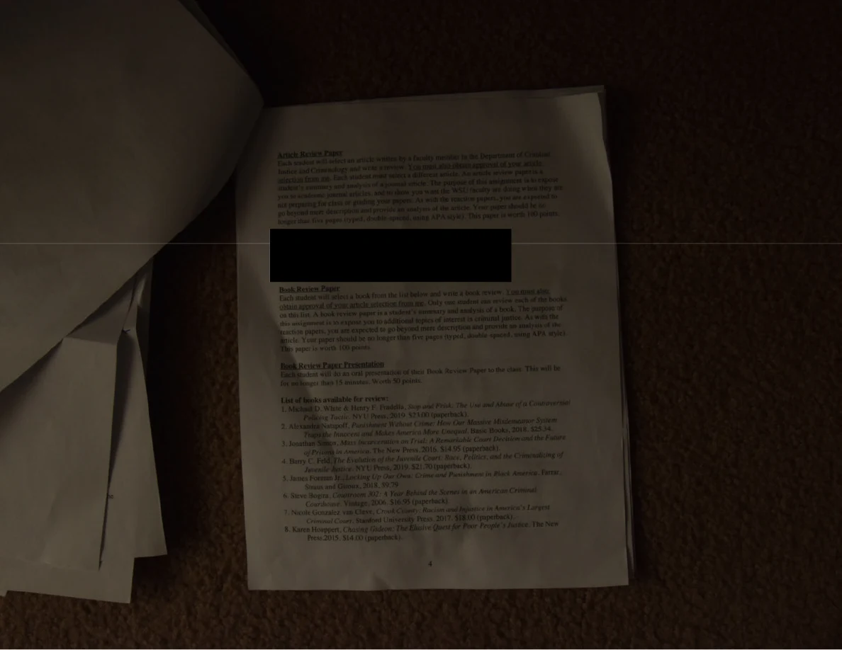 Dim course handout with a black redaction bar and a reading list.