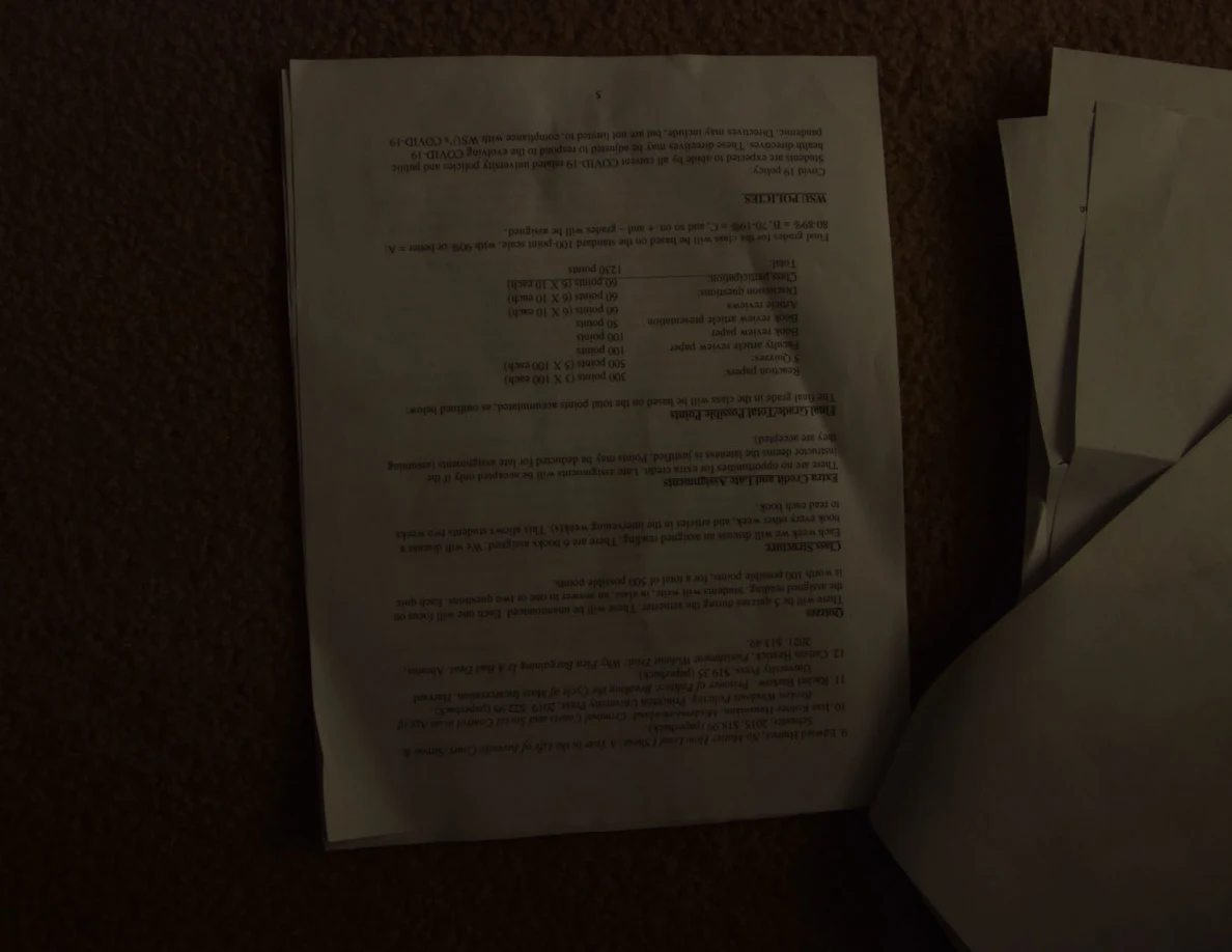 Dim upside-down course handout with a grading table.