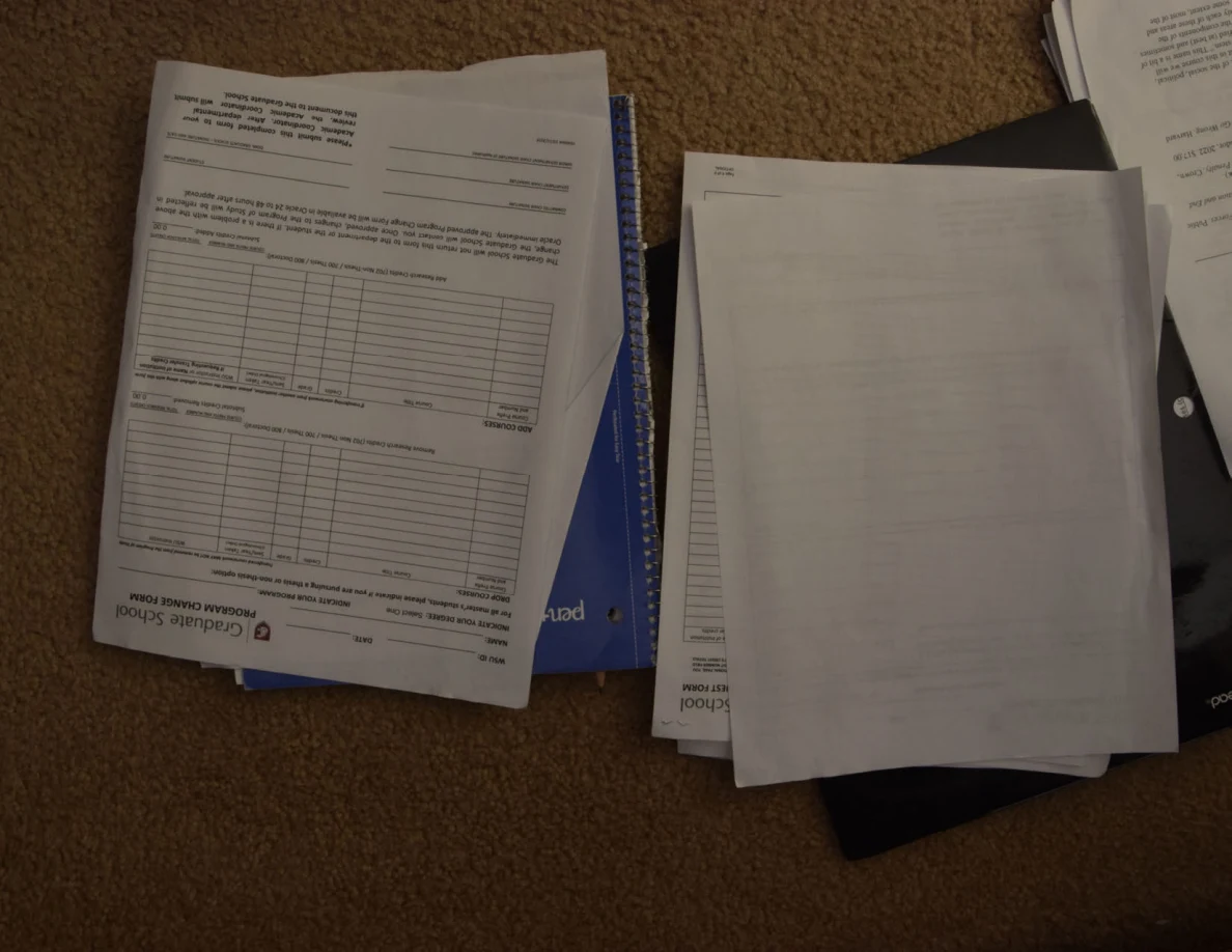 Graduate-school form with two tables beside a turned page.