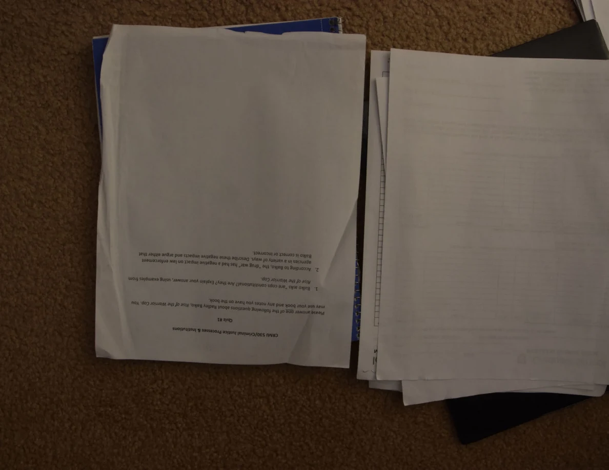 Mostly blank paper and lined sheets on two stacks of documents.