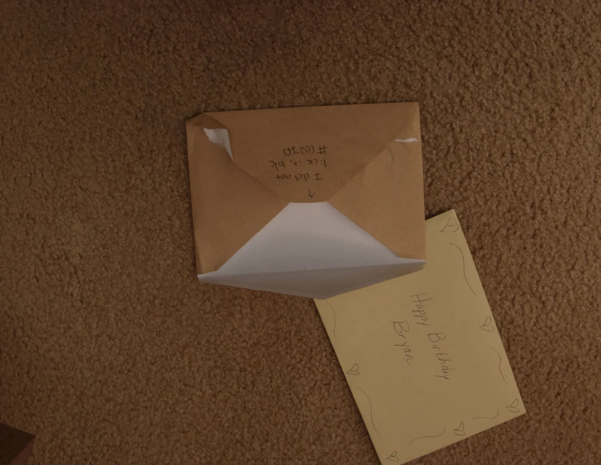 Brown envelope with open flap beside a yellow greeting card.