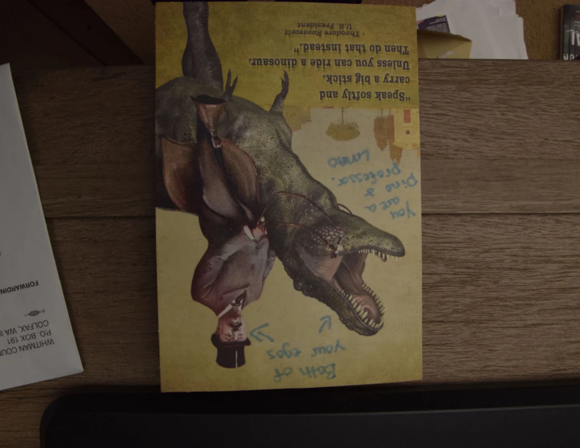 Illustrated birthday card with a dinosaur and person, with handwritten notes around the picture.