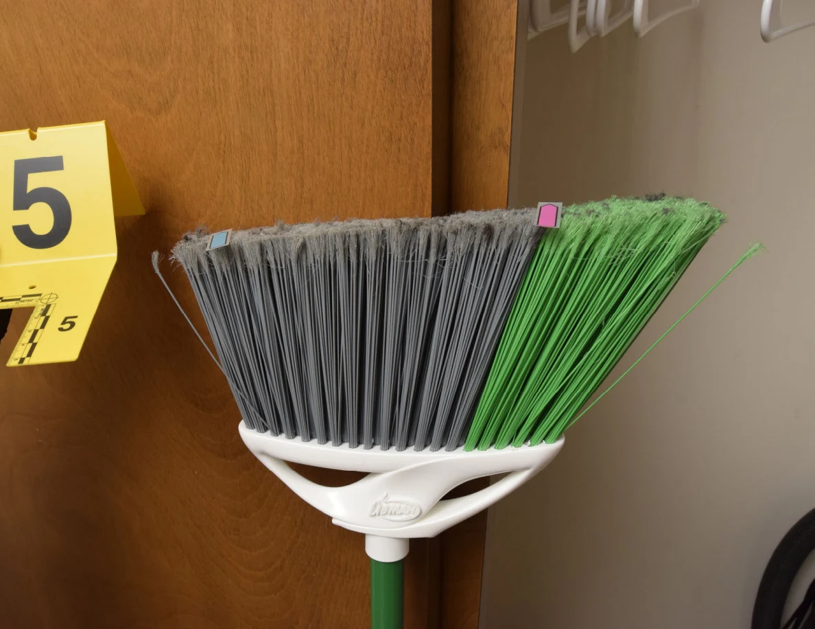 Broom head with gray and green bristles beside yellow marker 5.