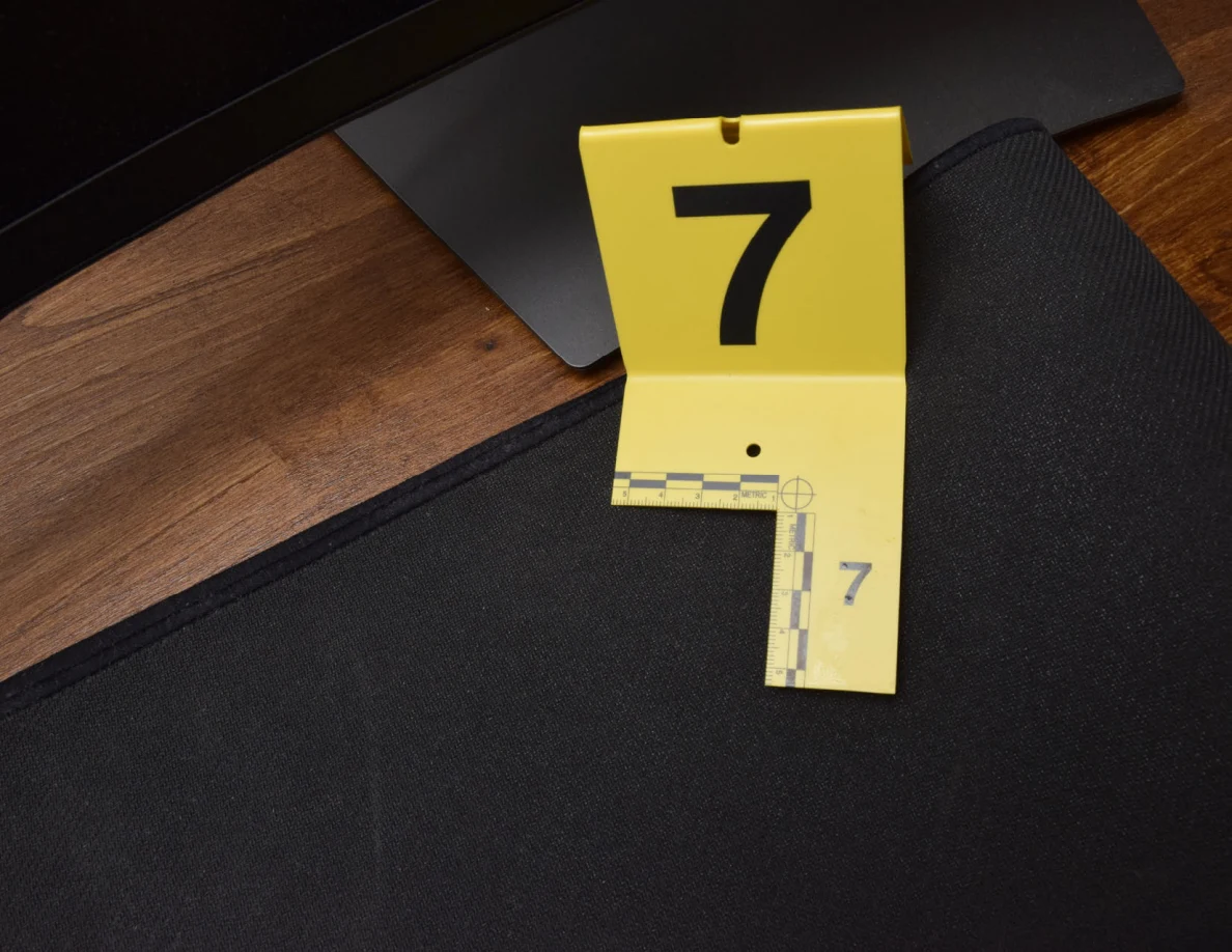 Close view of yellow marker 7 and measuring scale on a black desk mat.