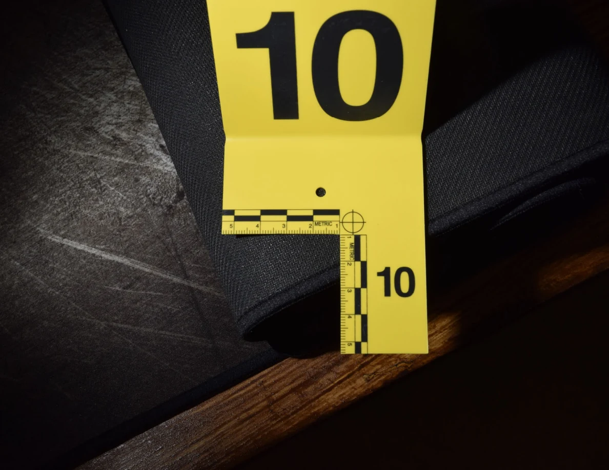 Close view of a folded desk-mat edge with yellow marker 10.