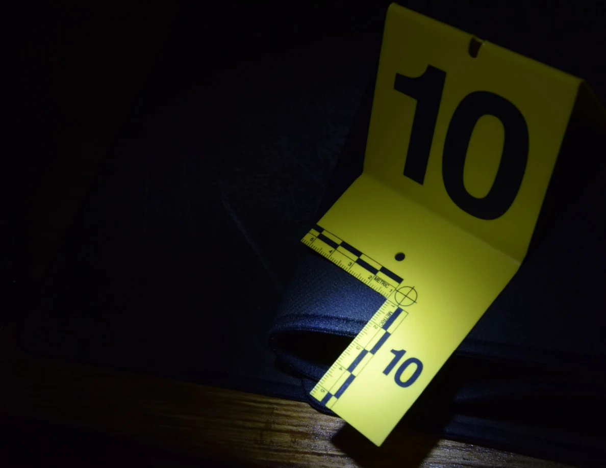 Dim close view of yellow marker 10 beside a folded black desk mat.