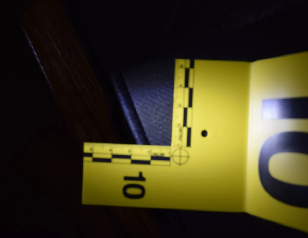 Illuminated yellow measuring scale beside the edge of a black desk mat.