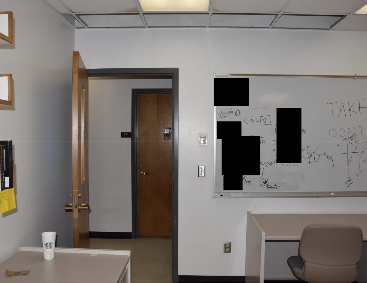 Upper office doorway and whiteboard with blacked-out writing.