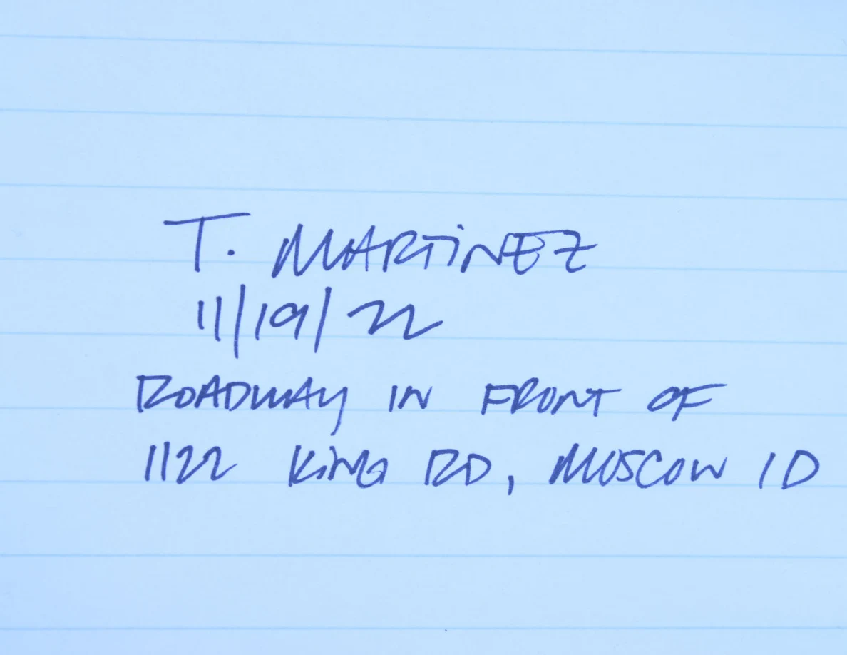 Lined paper with handwritten name, date and roadway location note.
