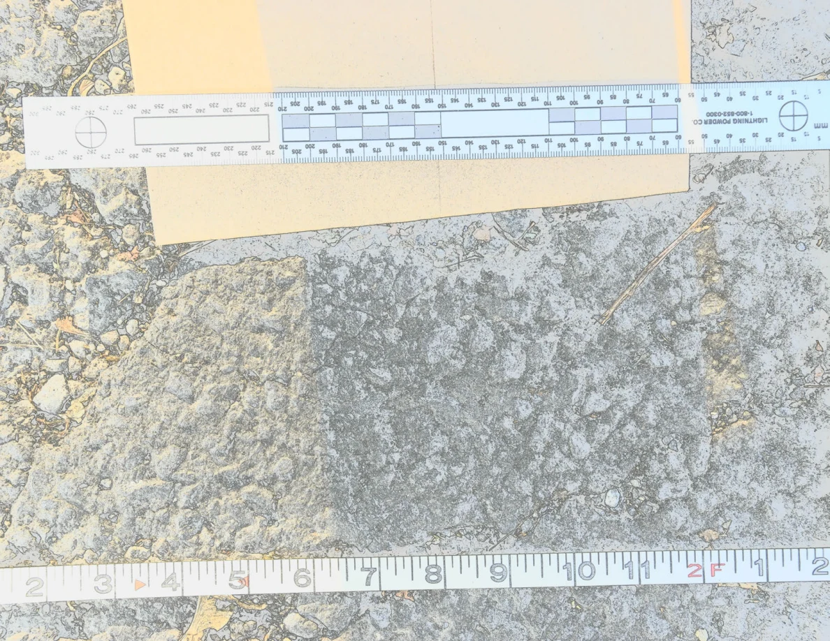 Measurement scales and a brown envelope above a textured patch of asphalt.