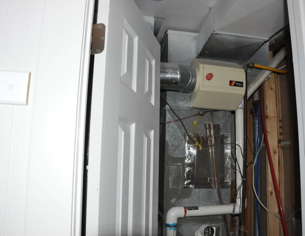 Upper utility doorway showing metal ductwork and ventilation equipment.