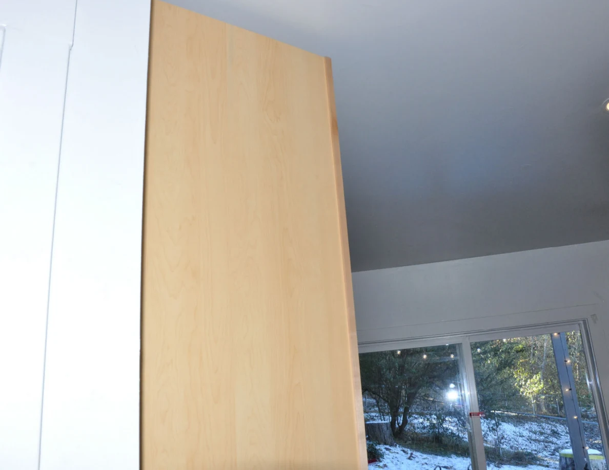 Upper wooden door edge and ceiling above a sliding glass door.