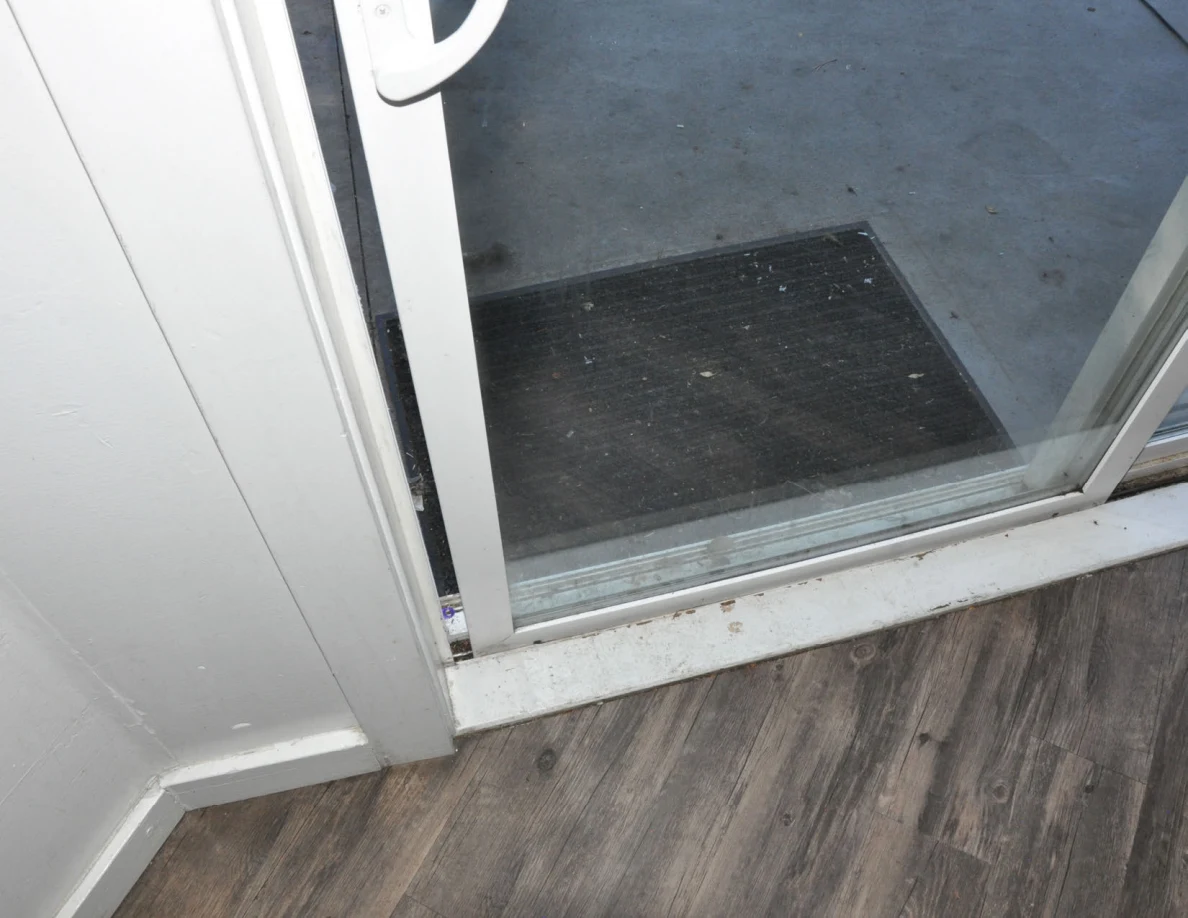 Lower sliding-glass door track and outdoor doormat.