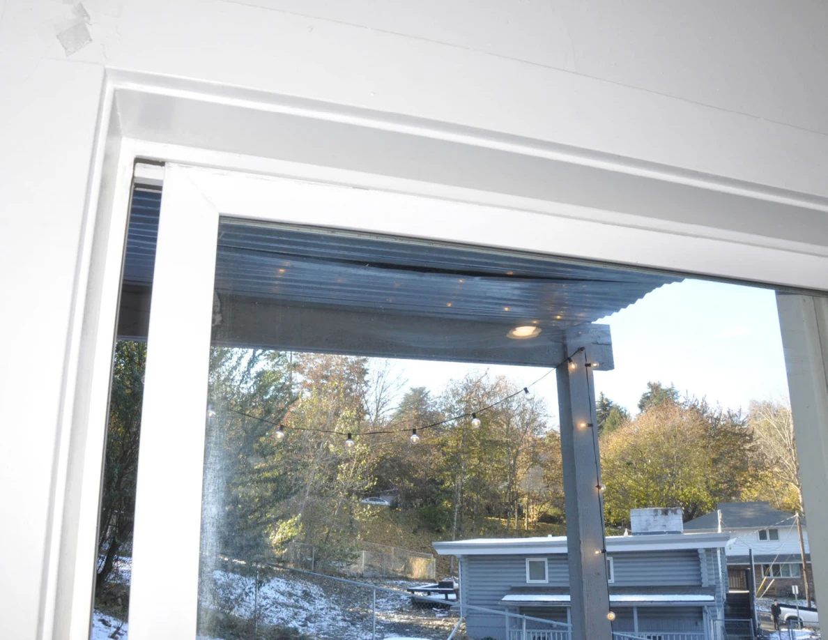 Upper sliding-glass door frame beneath a covered patio roof.