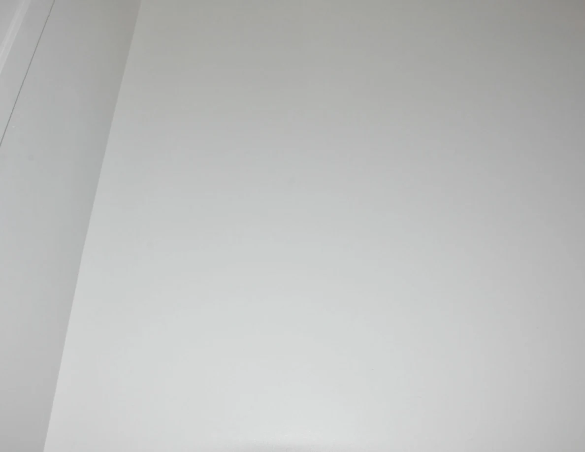 Plain white stairwell wall at an inside corner.