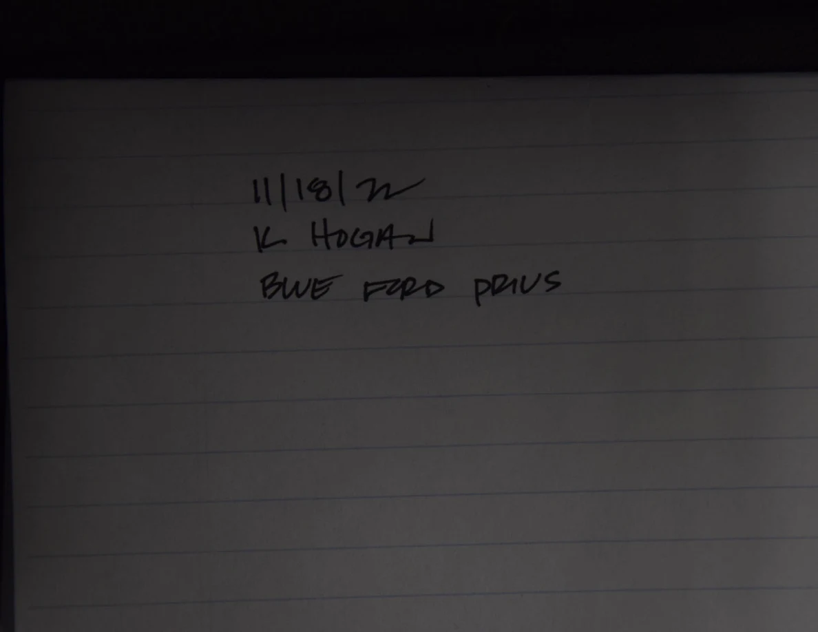 Second view of a handwritten identification card on lined paper referring to a blue Toyota Prius.