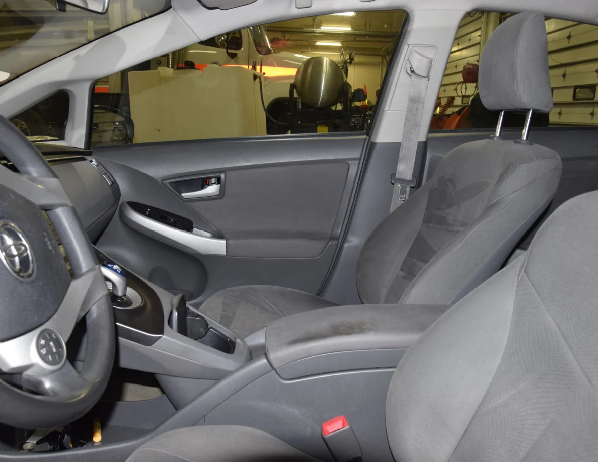 Front passenger seat and door panel beside center console and steering wheel.
