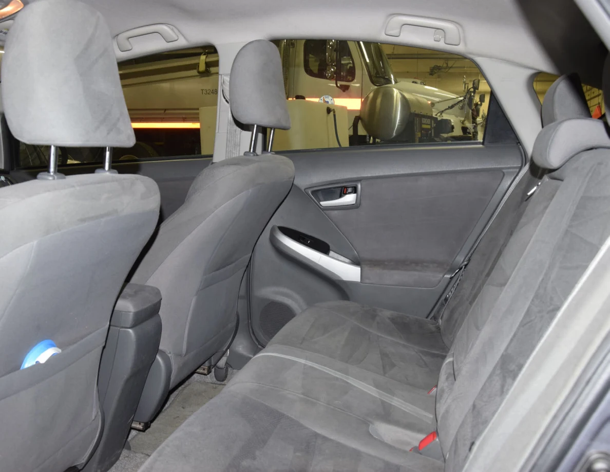 Gray rear bench seat, seat belts and the backs of front seats.