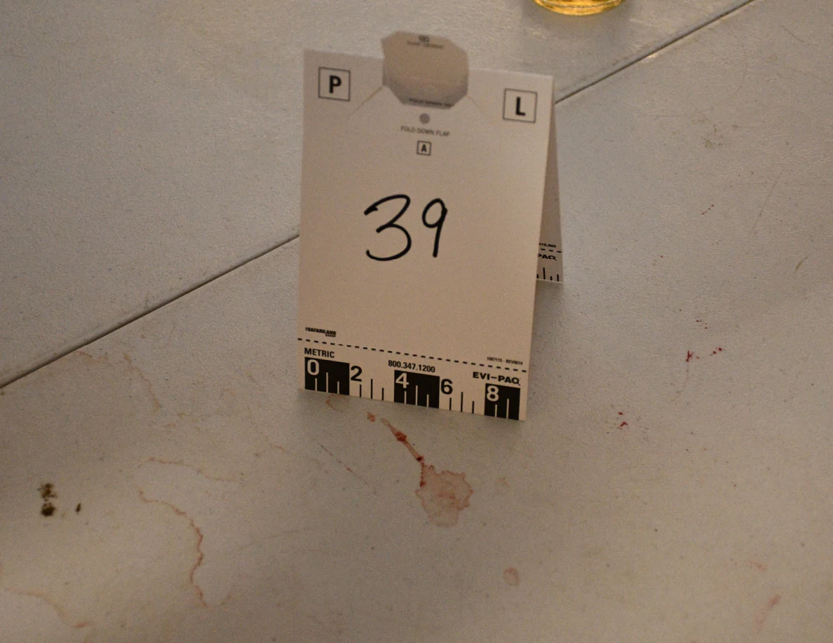 Card 39 placed beside reddish marks on a white folding tabletop.