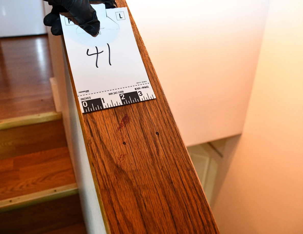 Card 41 held above reddish marks on a wooden stair cap.