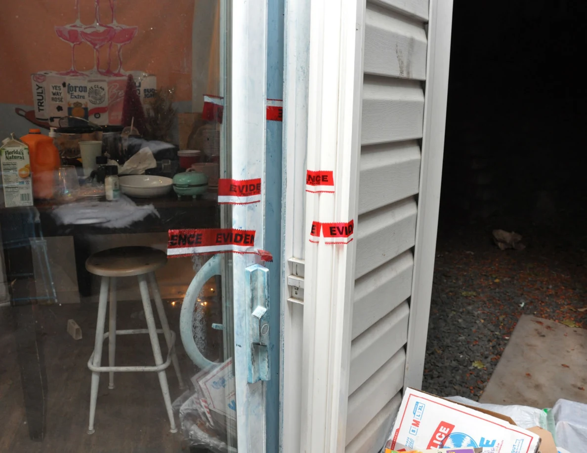 Sliding-door handle and frame with blue residue and red evidence tape.