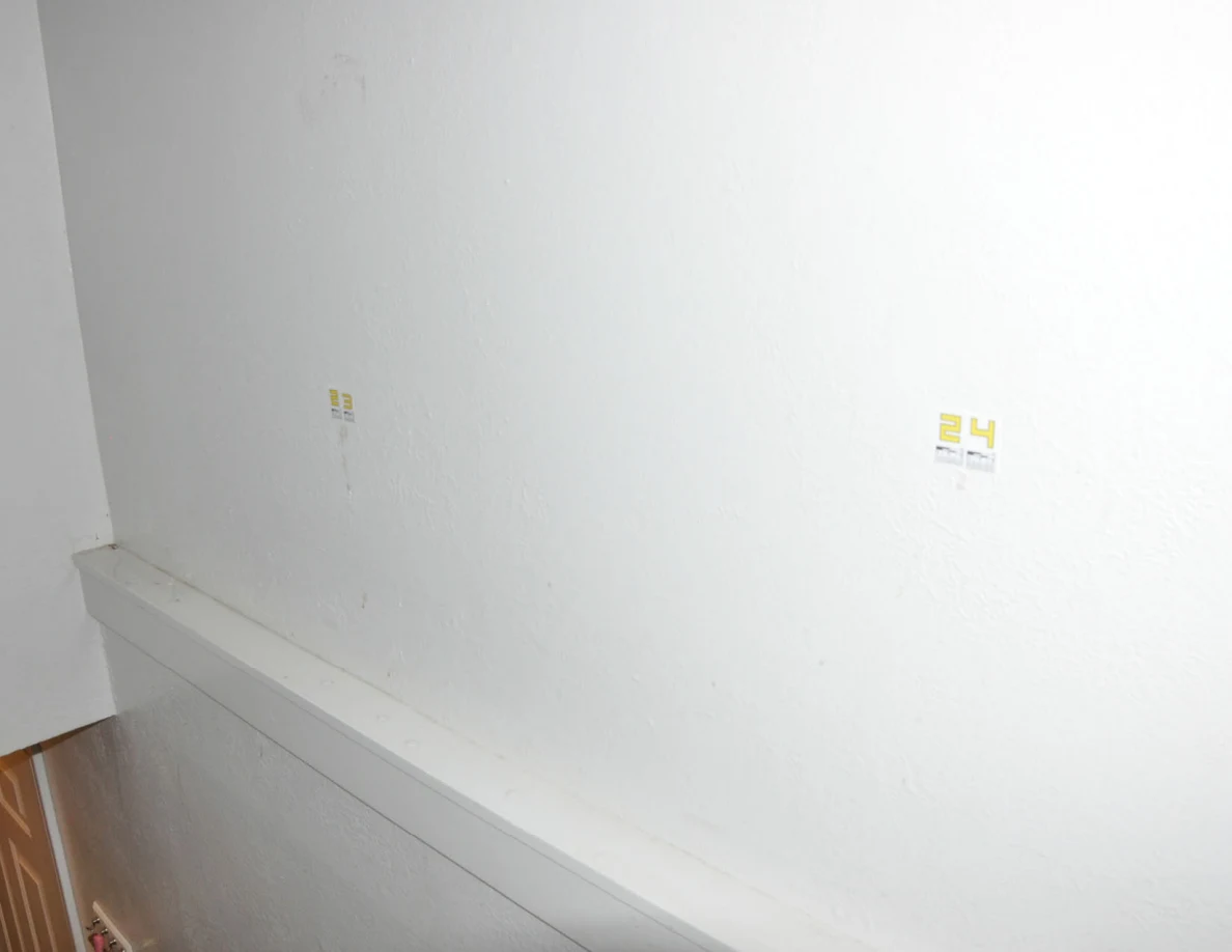 Bright view of labels 23 and 24 on a pale stairwell wall.
