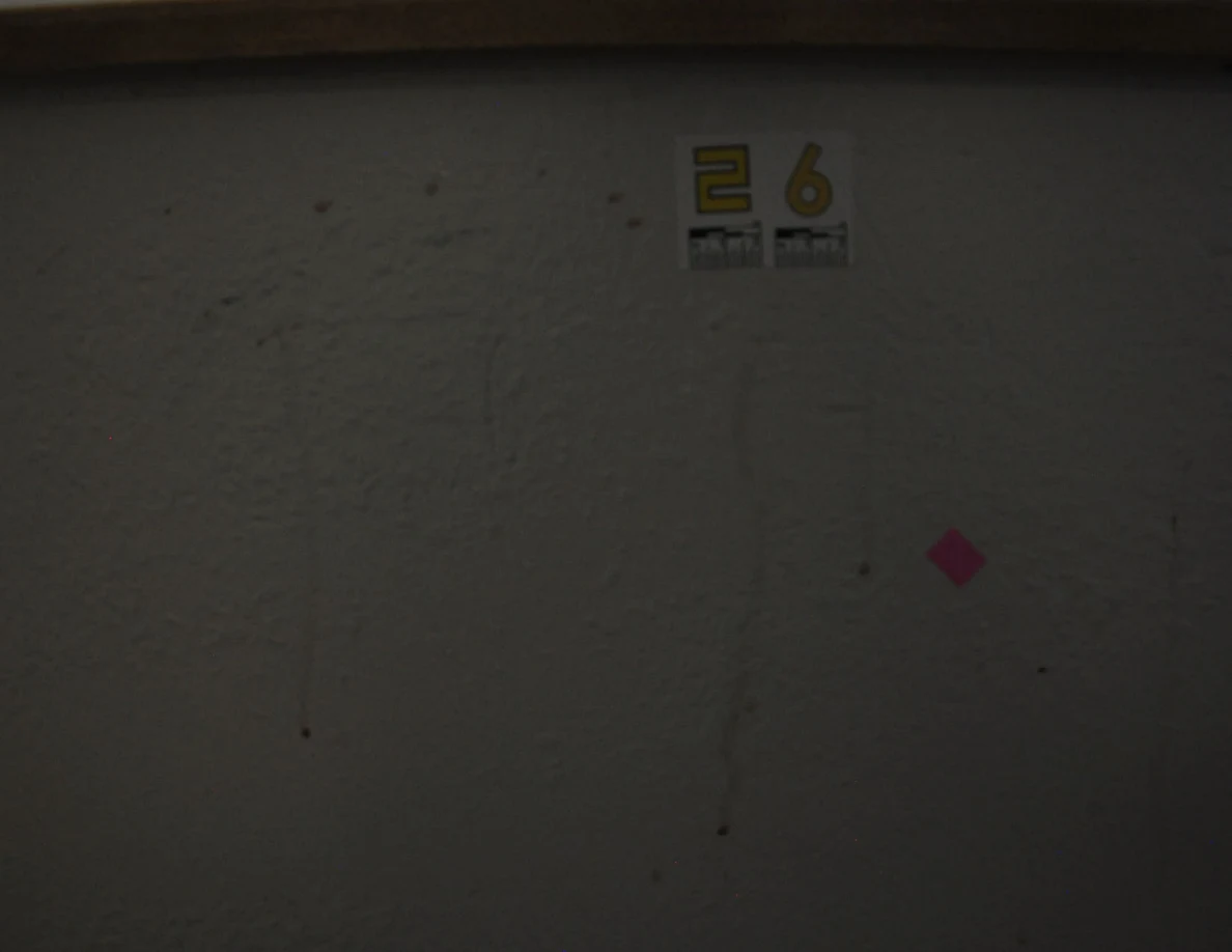 Dim view of label 26, pink tape and two thin vertical streaks.