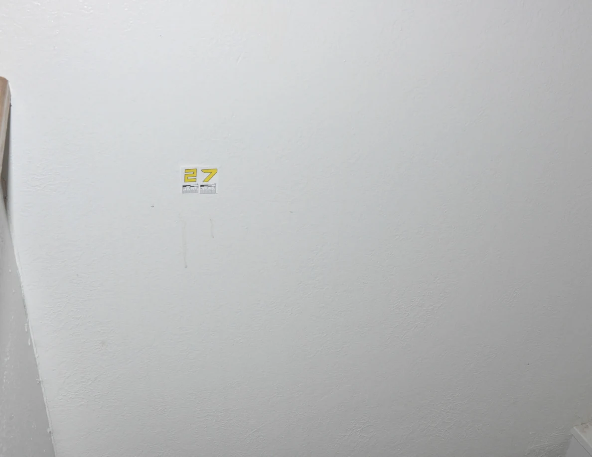 Yellow label 27 above two faint vertical wall marks.