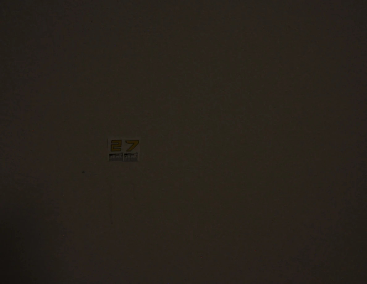 Dim view of label 27 and faint wall marks.