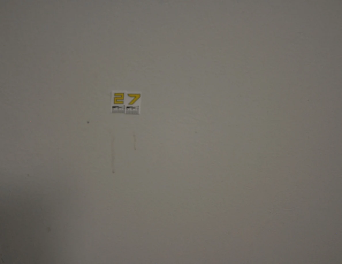Closer view of label 27 with two faint vertical marks below.