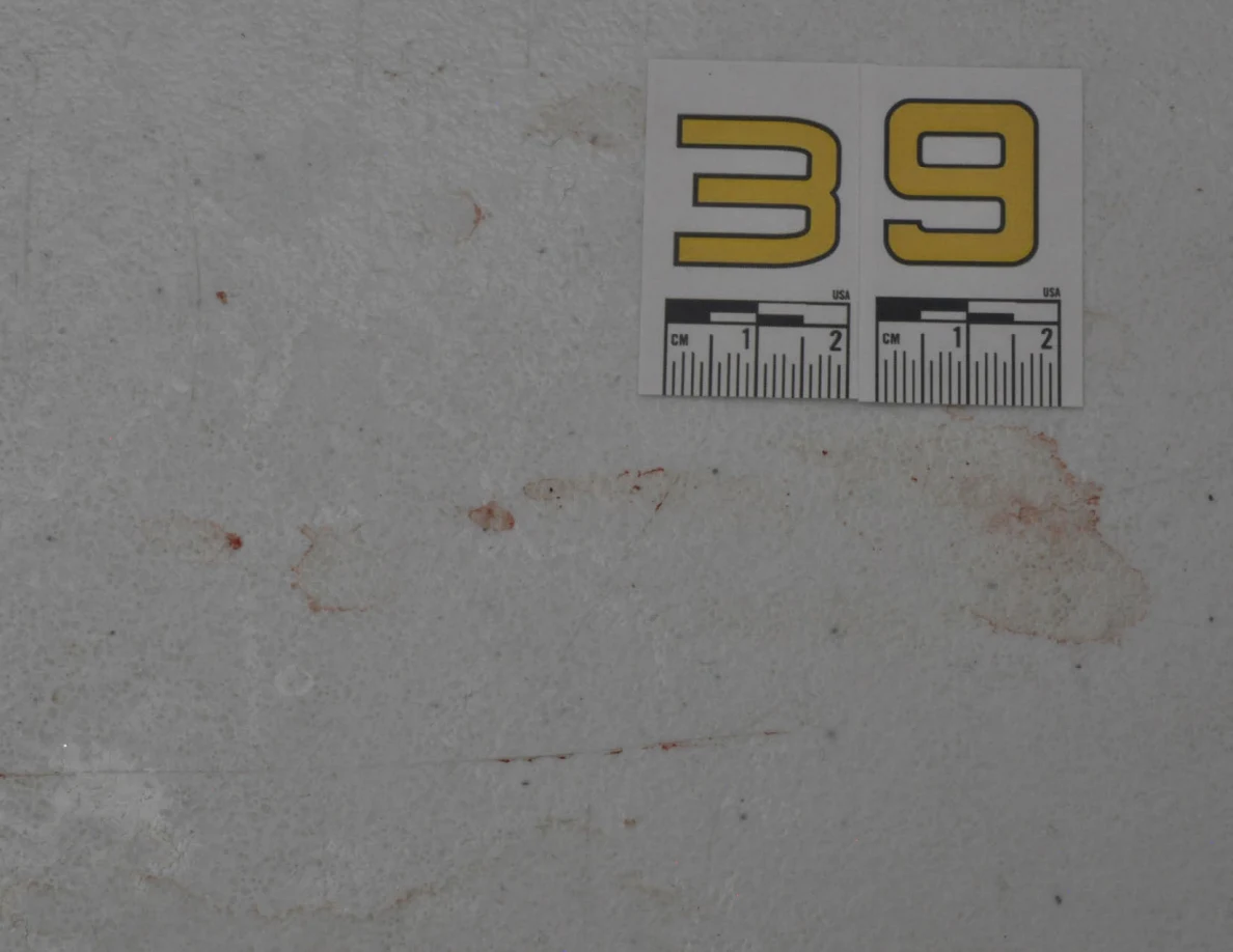 Yellow label 39 beside reddish smears and faint ring-shaped marks.