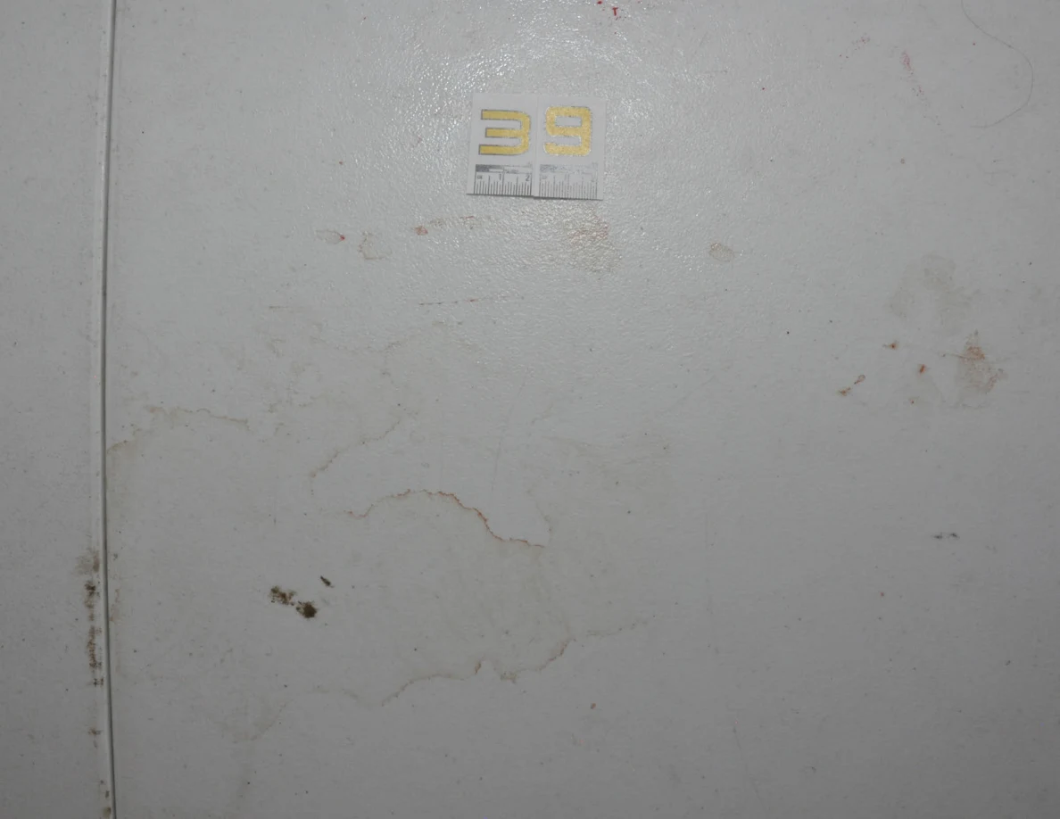 Label 39 on a white tabletop beside faint rings, smears and small dark marks.