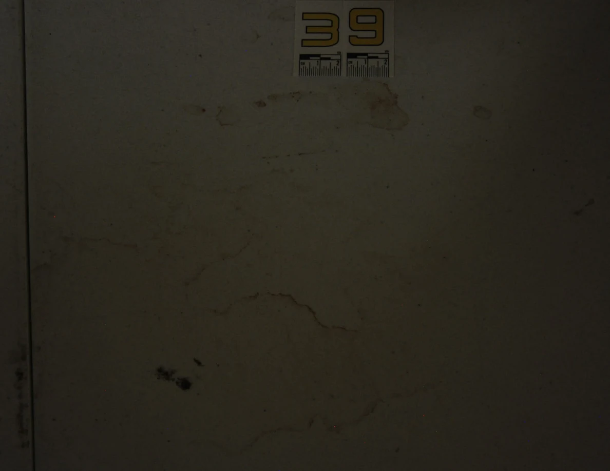 Dim close view of label 39 and ring-shaped marks on a white tabletop.