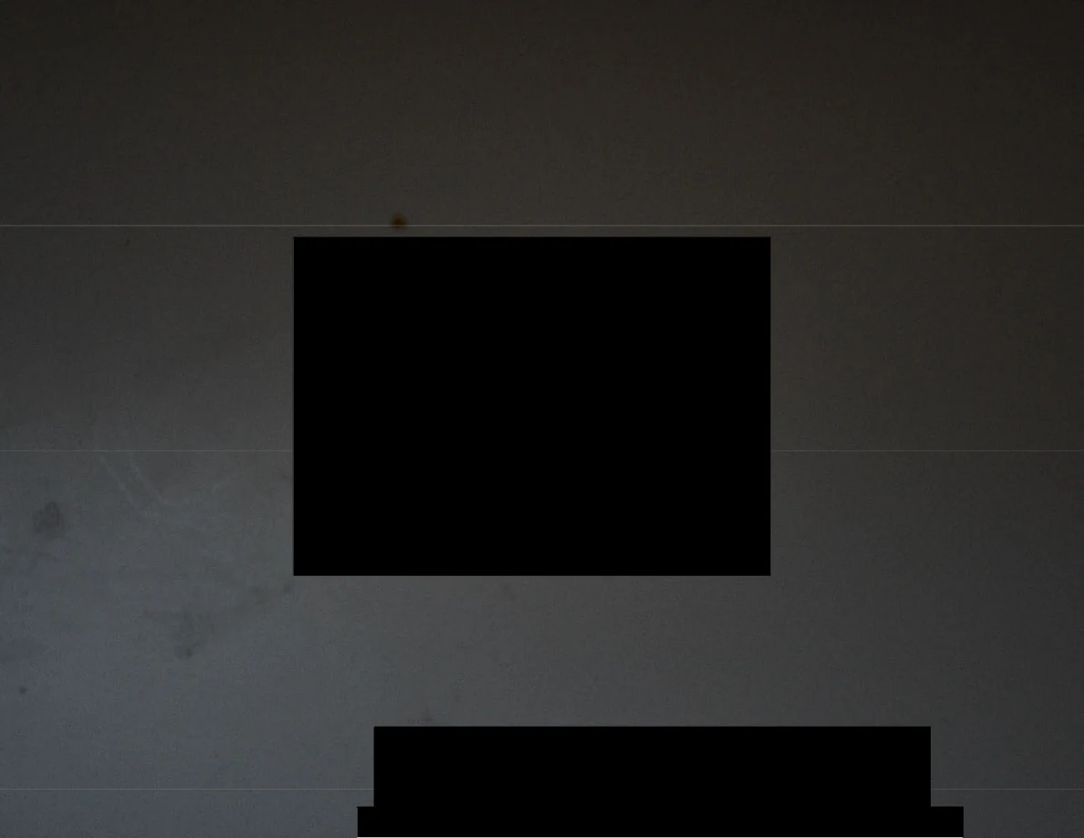 Dim close view of a pale surface with large black redactions obscuring the items.