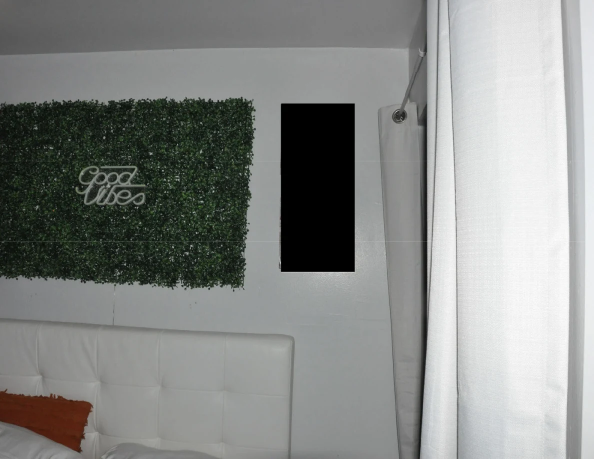 Good Vibes greenery panel above a white upholstered headboard.
