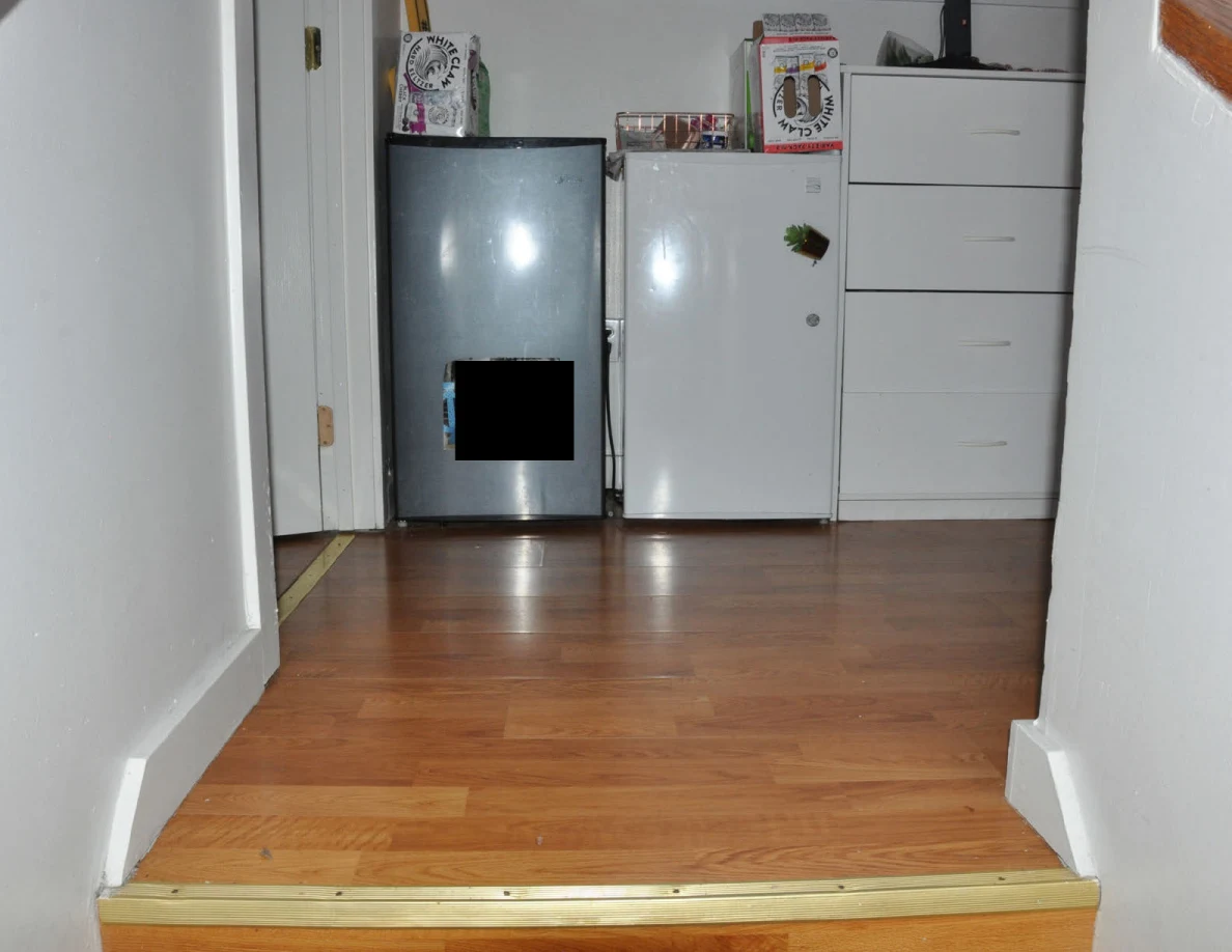Landing with black and white mini refrigerators beside a white drawer unit.