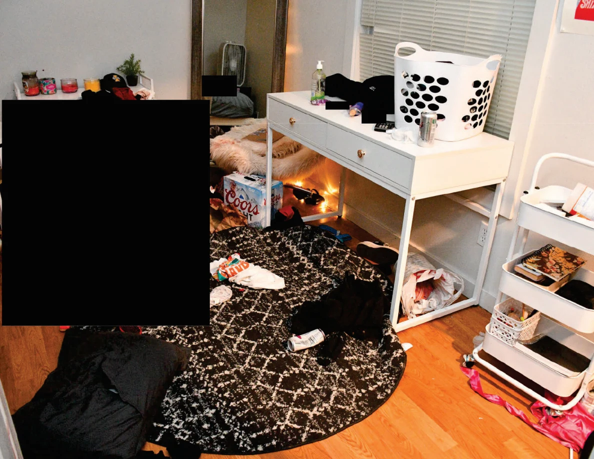 White desk with laundry basket beside a rolling cart and dark patterned round rug; a large area is redacted.