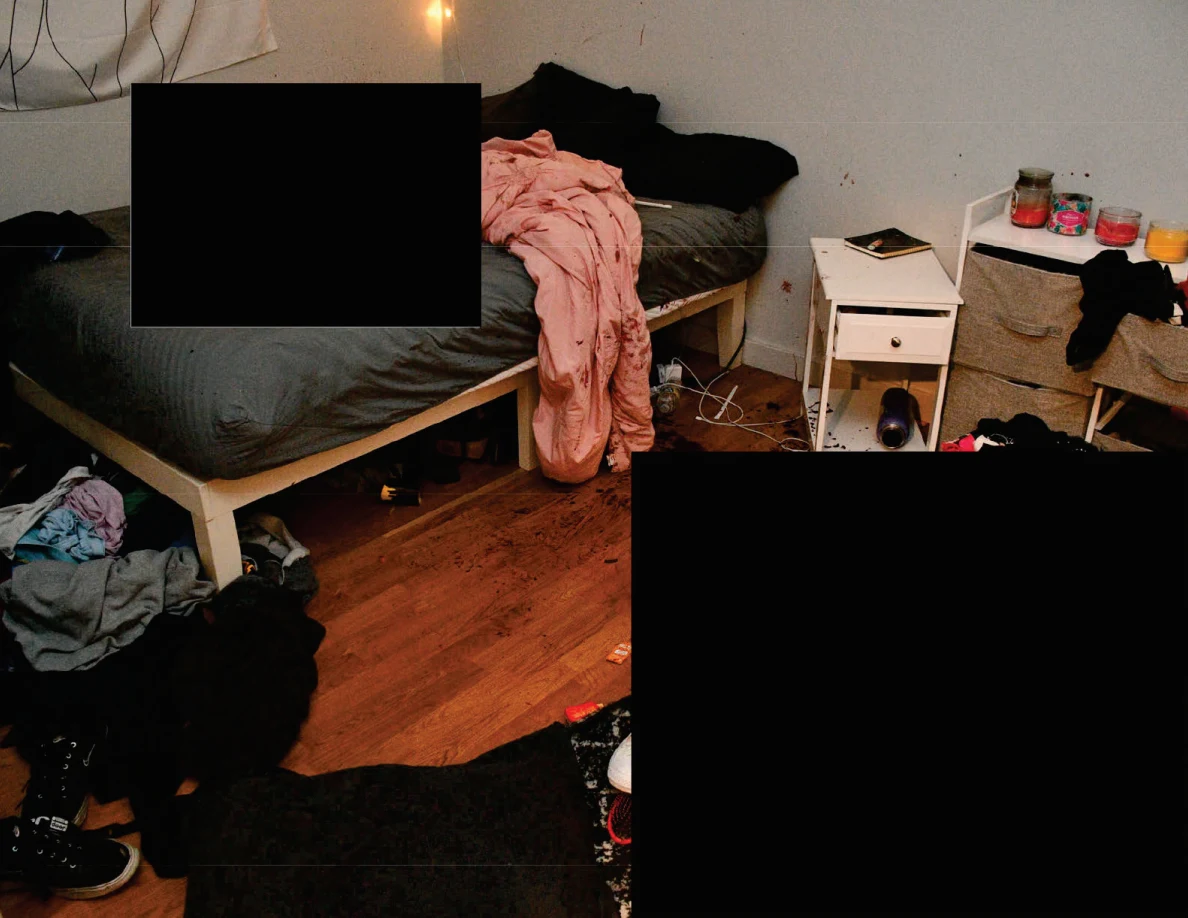 Bedside floor and furniture with loose clothing and shoes, with large black redactions.