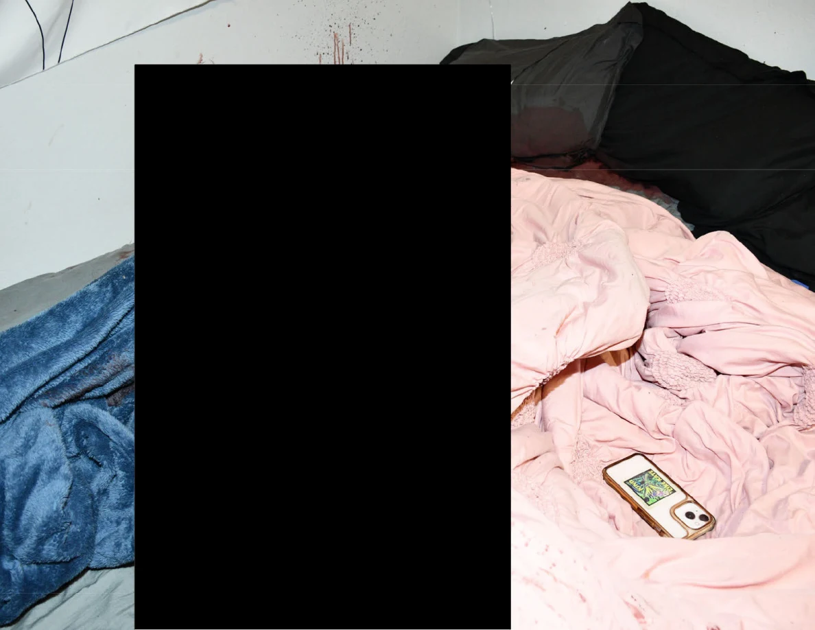 Phone on pink bedding beside a blue blanket and dark pillows, with a large redaction across the bed.