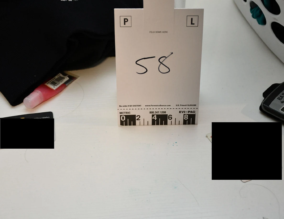 Scale card 58 on a white desktop beside a calculator and blacked-out areas.