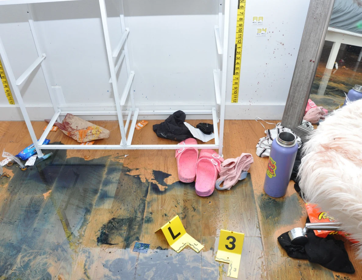 Open white drawer frame above dark floor marks beside pink slides and a purple bottle.