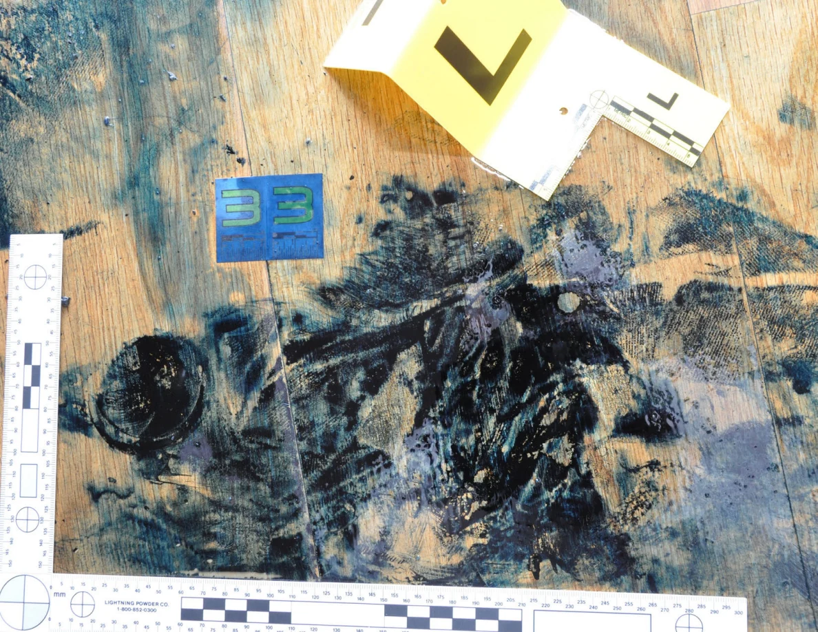 L-shaped white measuring scale around dark floor marks beside a blue card and yellow L marker.