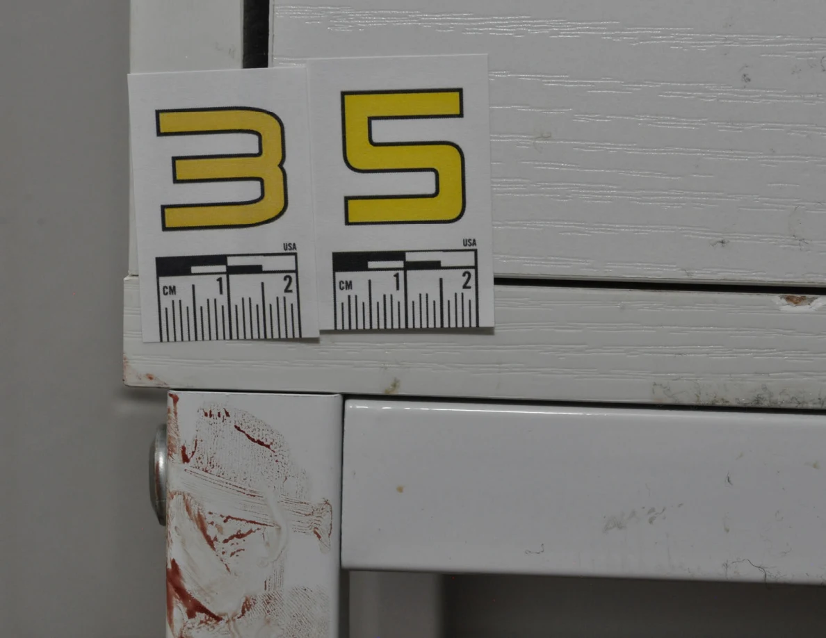 Close view of scale label 35 beside a white desk drawer and reddish marks.