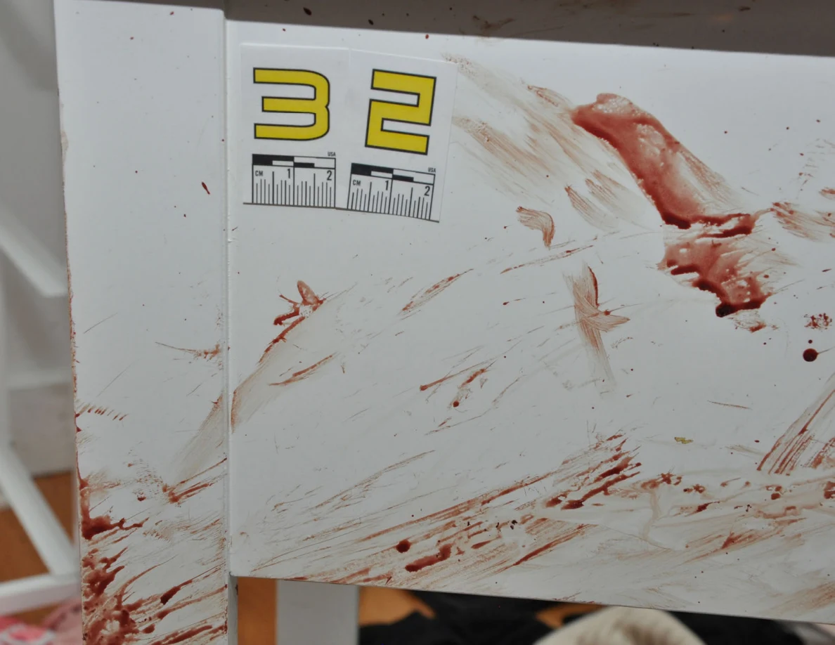 Close view of reddish cabinet smears beside scale label 32.