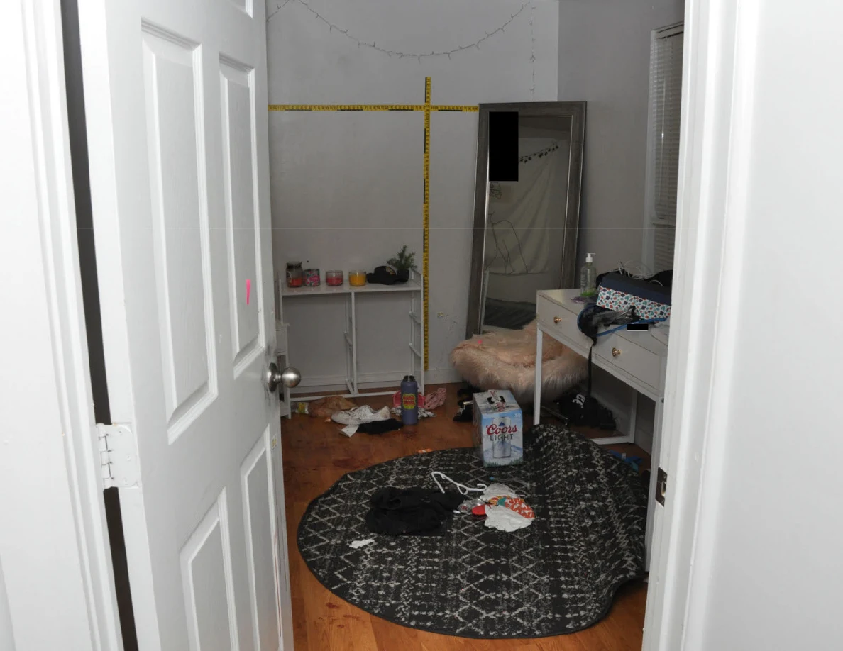 White bedroom furniture beneath yellow wall scales beside a round patterned rug.