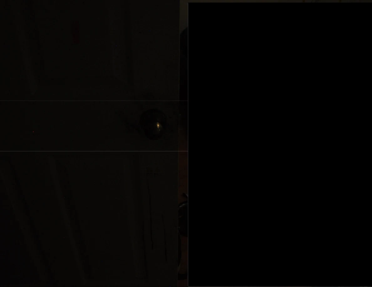 Very dim partly redacted view with a door knob visible.
