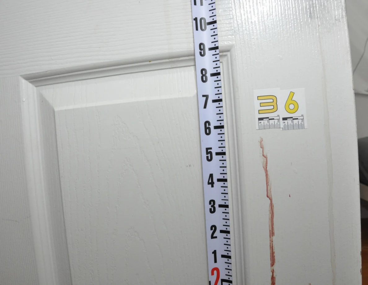 Vertical measuring ruler beside scale label 36 and a reddish door streak.