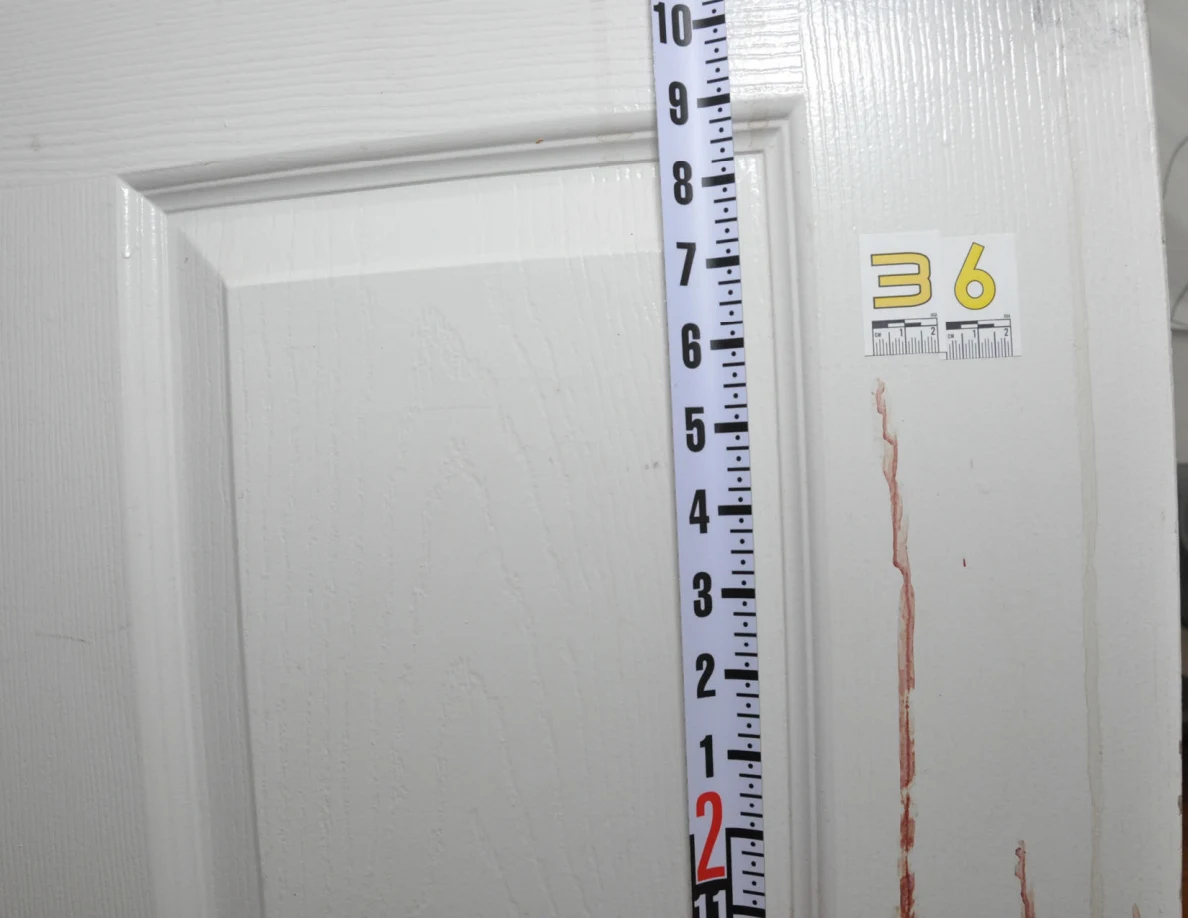 Measuring ruler beside scale label 36 on a white door.