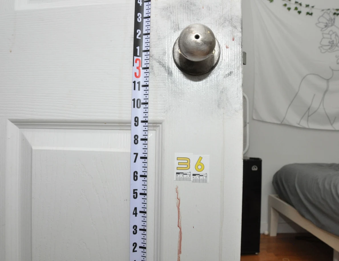 Door knob and reddish streaks beside a long ruler and label 36.