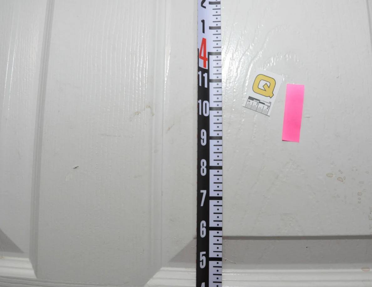 Measuring ruler beside pink tape and scale label Q.